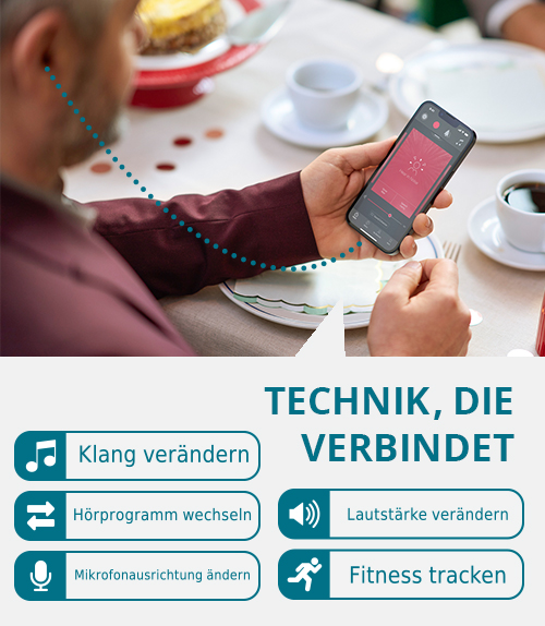 Mann bedient Smatrphone-App mit vielfältigen Funktionen zur Einstellung von Hörgeräten